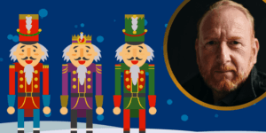 Three colourful nutcracker figures stand side by side with a portrait of a man in a circle beside them, set against a blue background with snowflakes.